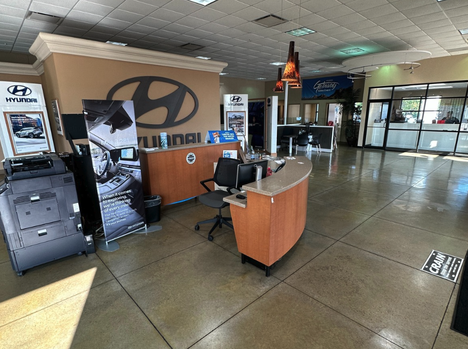 Inside view of the Crain Hyundai of Bentonville finance department with desks and Hyundai branding